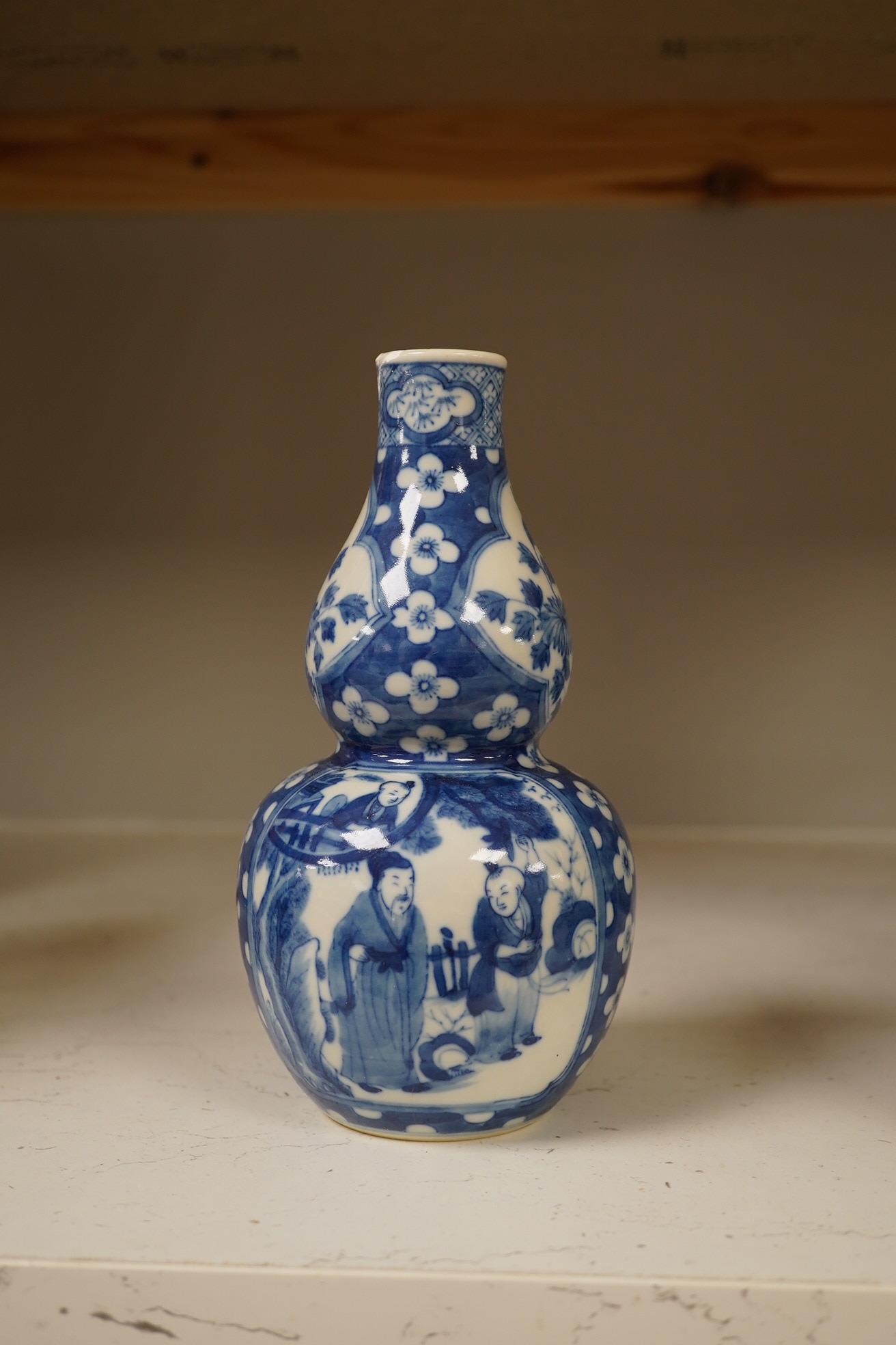 Two Chinese vases; a blue and white double gourd vase and famille noir vase, famille noir 19cm high. Condition - good